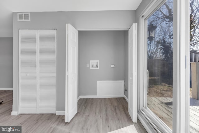 interior space with a closet, light wood-type flooring, visible vents, and baseboards