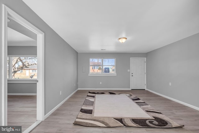 entryway with wood finished floors and baseboards