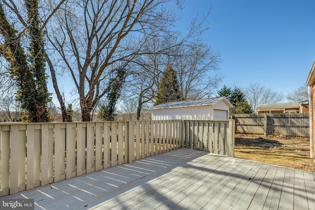 wooden terrace with an outbuilding and fence