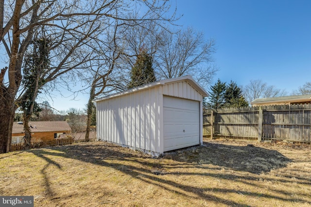 detached garage featuring fence