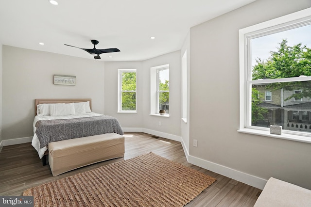 bedroom with recessed lighting, baseboards, and wood finished floors