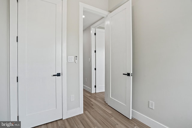 unfurnished bedroom featuring light wood-type flooring and baseboards