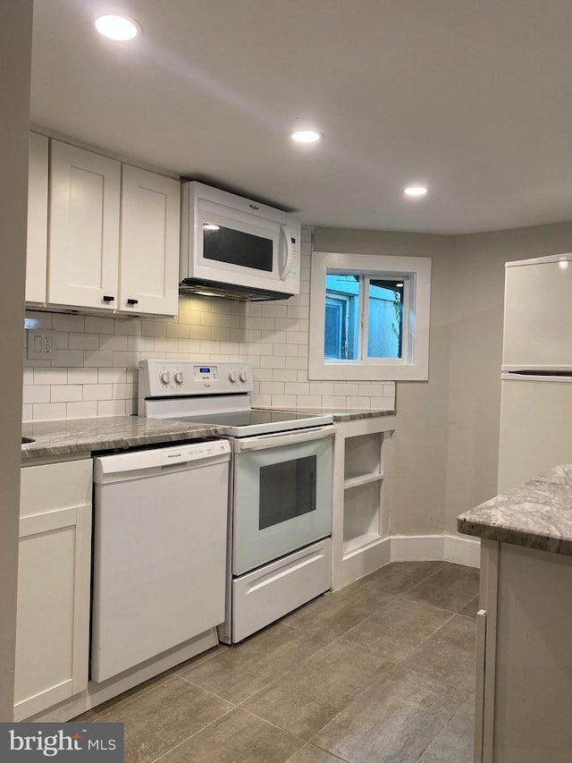 kitchen with white appliances, baseboards, decorative backsplash, white cabinetry, and recessed lighting