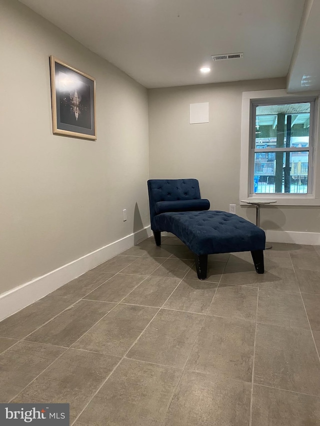 sitting room featuring tile patterned floors, visible vents, and baseboards