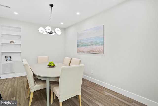 dining room with recessed lighting, visible vents, baseboards, and wood finished floors