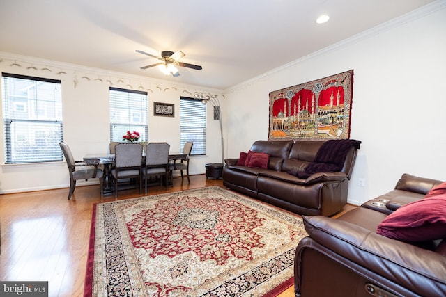 living area with crown molding, recessed lighting, wood-type flooring, ceiling fan, and baseboards