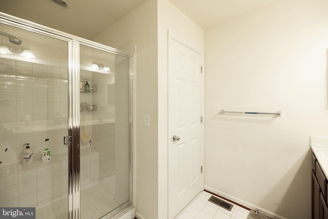 full bathroom with a stall shower, visible vents, baseboards, tile patterned flooring, and vanity