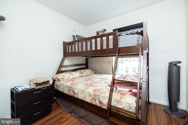 bedroom featuring baseboards and wood finished floors