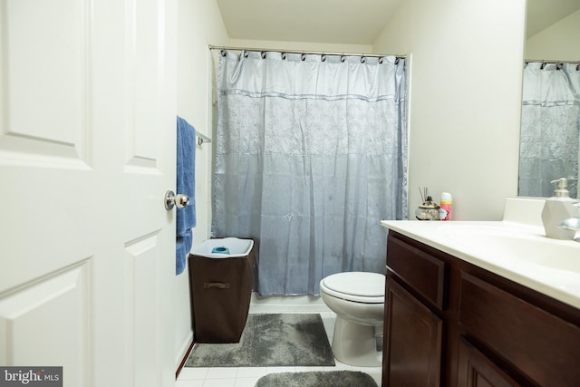 full bathroom featuring toilet, tile patterned flooring, and vanity