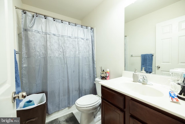 bathroom with tile patterned flooring, a shower with curtain, vanity, and toilet