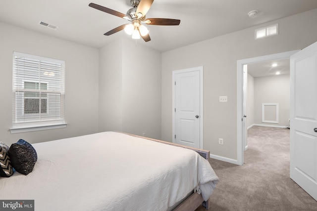 bedroom with carpet floors, visible vents, baseboards, and a ceiling fan