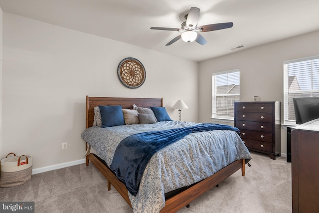 bedroom featuring multiple windows, visible vents, and light colored carpet