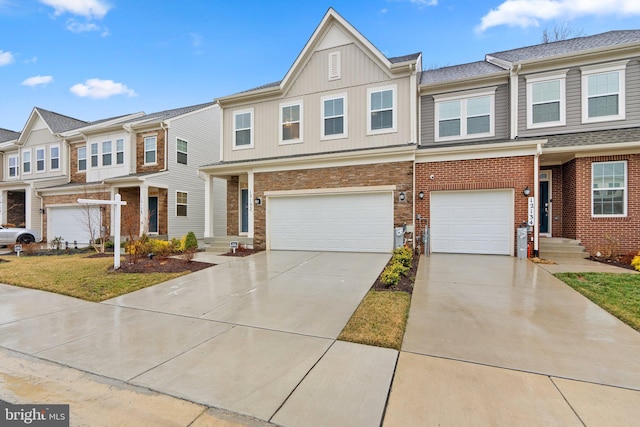 townhome / multi-family property featuring a garage, concrete driveway, and brick siding