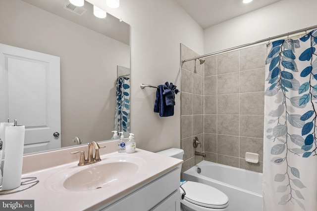 full bath featuring toilet, shower / bath combo, visible vents, and vanity