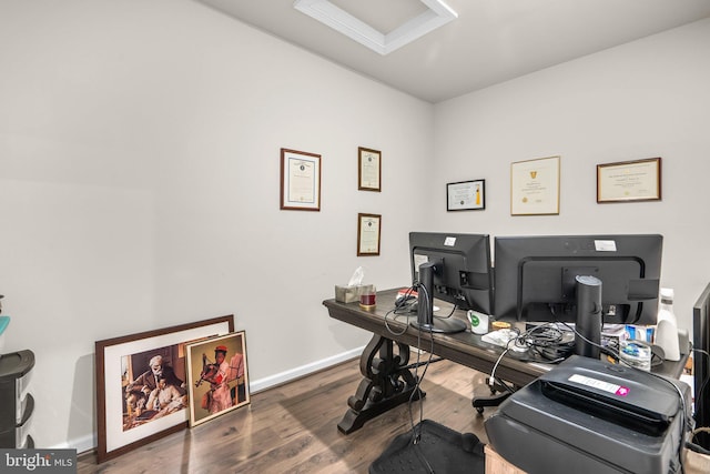 home office featuring baseboards and wood finished floors