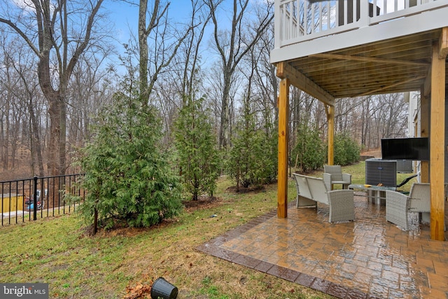 view of yard featuring central AC unit, fence, and a patio