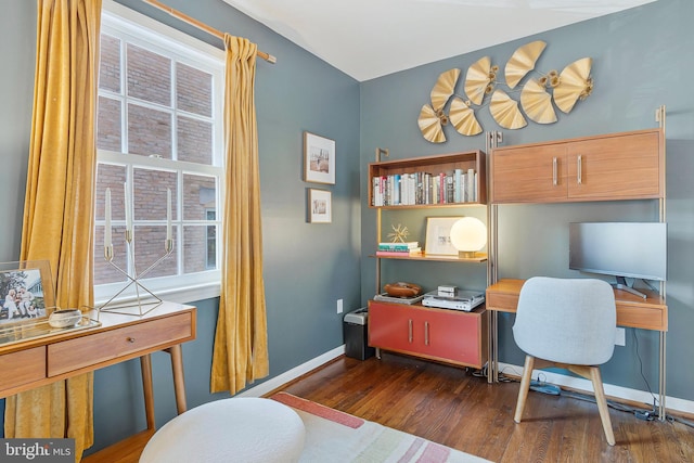 home office with baseboards and wood finished floors