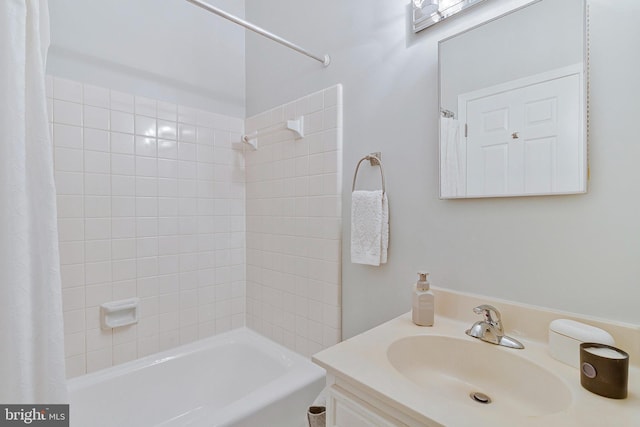 bathroom featuring shower / bath combo with shower curtain and vanity