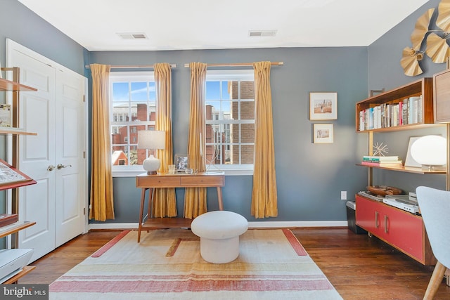 interior space featuring visible vents, baseboards, and wood finished floors