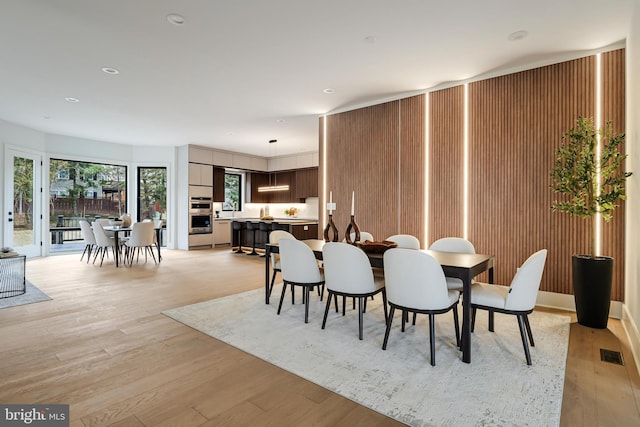 dining space featuring recessed lighting, visible vents, and light wood-style floors