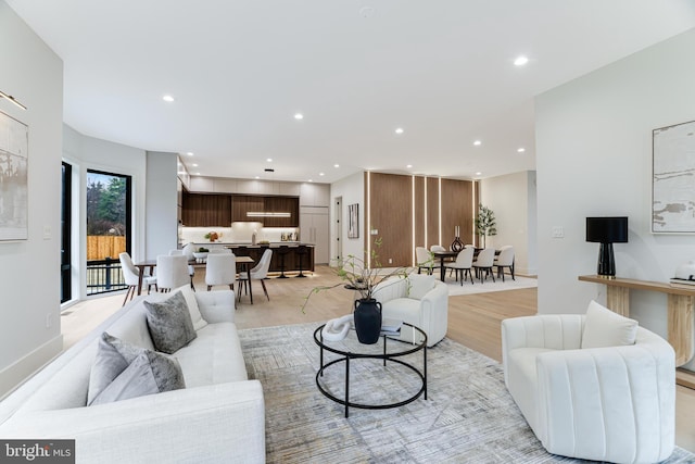 living room featuring light wood-type flooring and recessed lighting