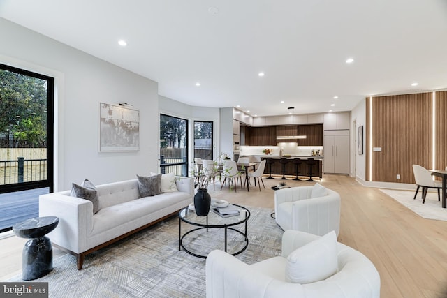 living room with light wood-style flooring, a wealth of natural light, and recessed lighting