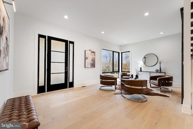 entrance foyer featuring baseboards, wood finished floors, visible vents, and recessed lighting