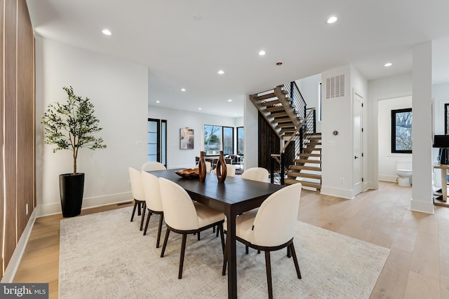 dining room featuring light wood-style floors, plenty of natural light, stairs, and recessed lighting