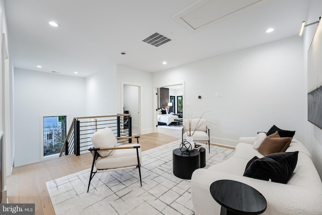 living room with baseboards, light wood finished floors, and recessed lighting