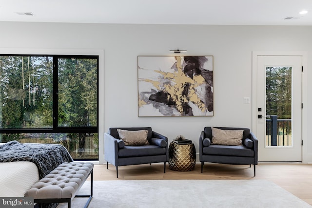 bedroom featuring multiple windows, wood finished floors, and visible vents