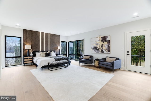 bedroom featuring access to outside, light wood-type flooring, visible vents, and recessed lighting