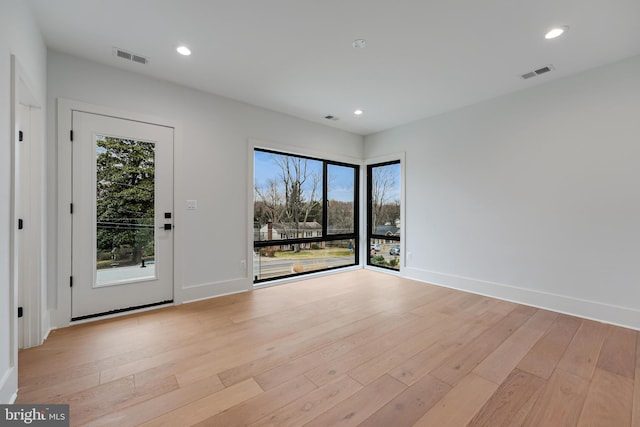 spare room with recessed lighting, visible vents, and light wood finished floors