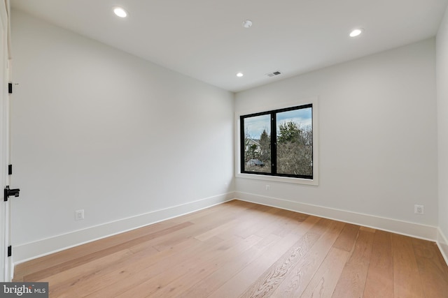 spare room featuring baseboards, recessed lighting, visible vents, and light wood-style floors