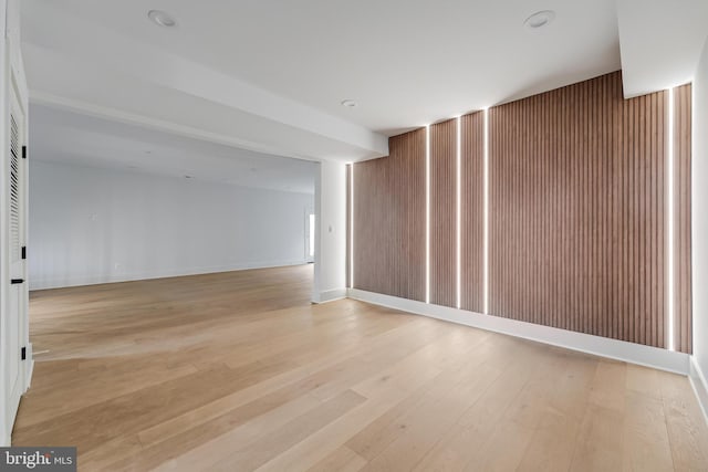 spare room featuring light wood-style floors and baseboards