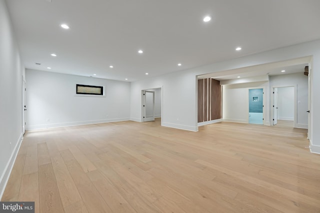 below grade area with baseboards, light wood-style floors, and recessed lighting