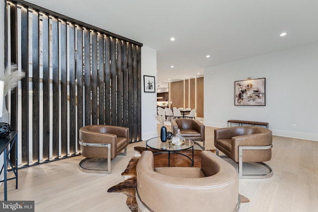 interior space with baseboards, wood finished floors, and recessed lighting