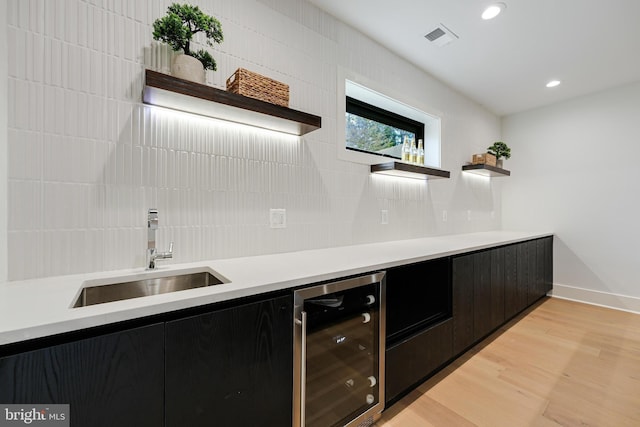 kitchen with beverage cooler, visible vents, a sink, and open shelves