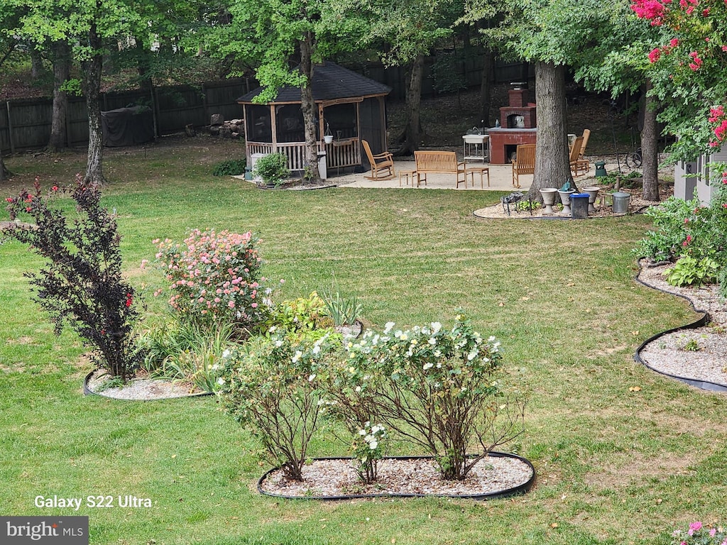 view of yard featuring a gazebo, a patio area, and fence