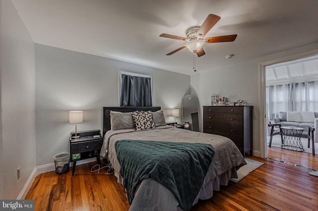 bedroom featuring ceiling fan, wood finished floors, and baseboards