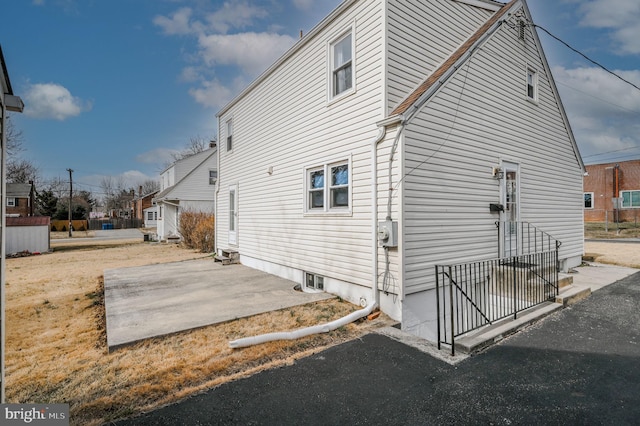 view of side of property featuring a patio area