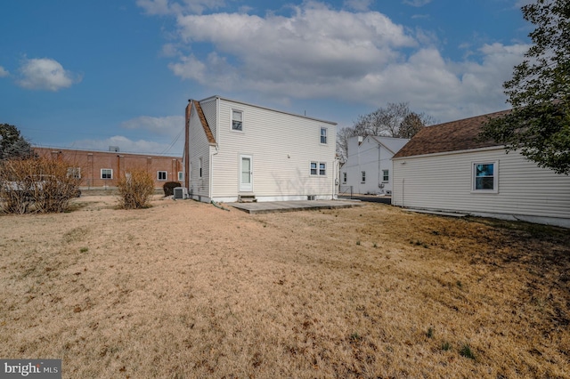 rear view of property with a yard and a patio