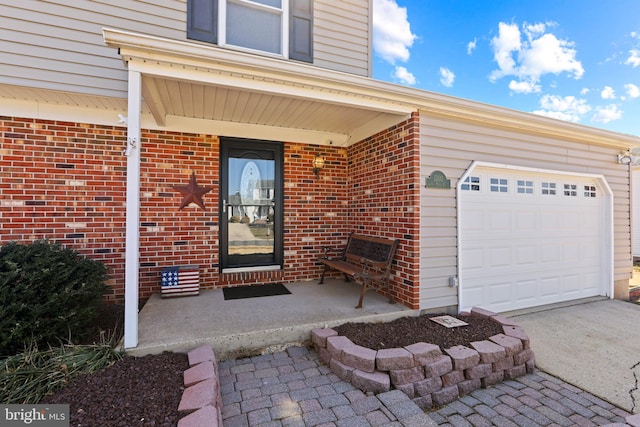 property entrance featuring a garage and brick siding