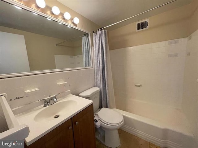 full bath featuring shower / bath combo, visible vents, toilet, vanity, and tile walls