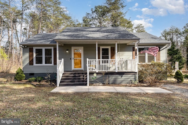 bungalow-style house featuring a shingled roof, covered porch, and crawl space