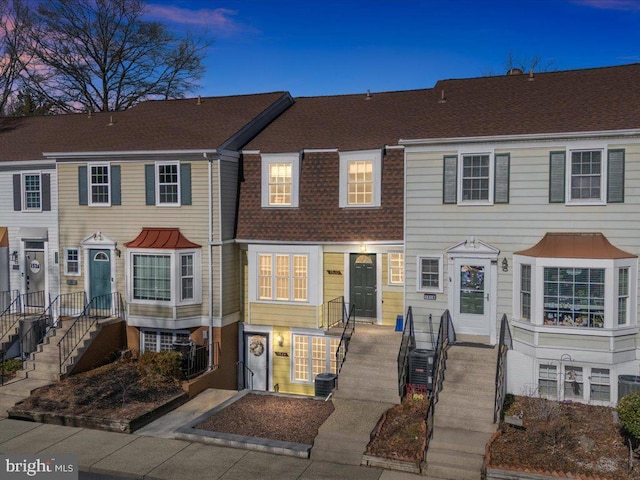 multi unit property featuring a shingled roof