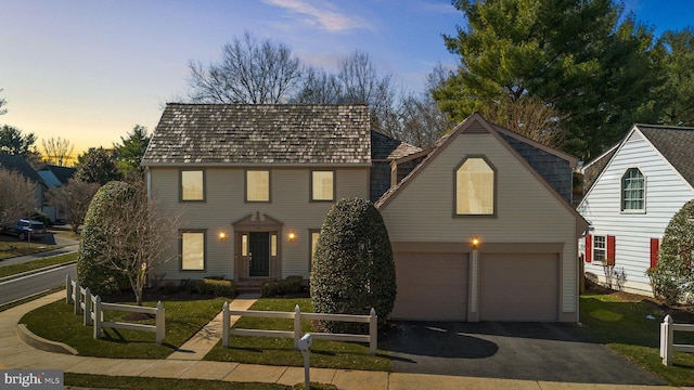 view of front of home with a fenced front yard, a front yard, and driveway