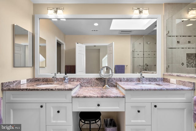 bathroom with visible vents, a stall shower, and vanity