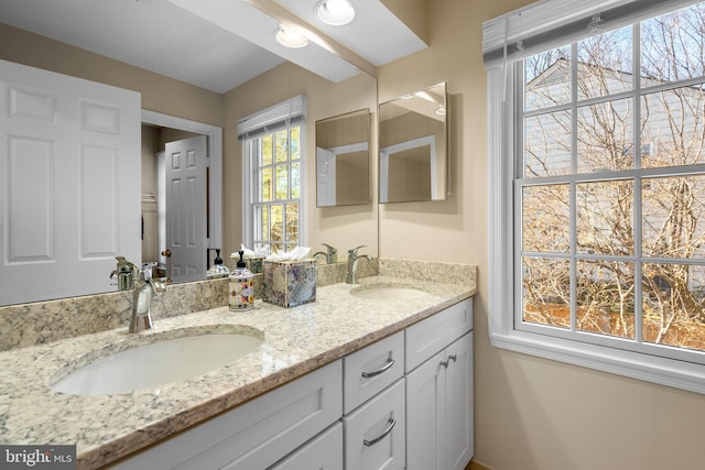 full bath with double vanity and a sink