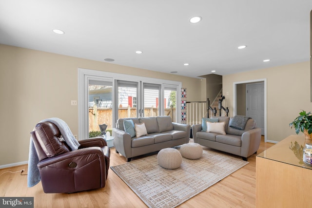 living room with stairway, recessed lighting, light wood-style flooring, and baseboards