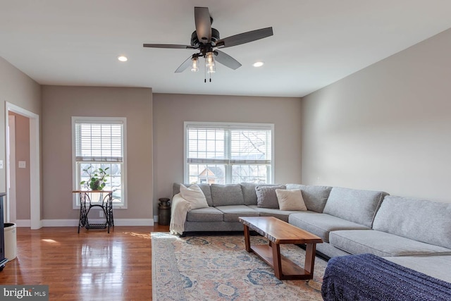 living area featuring ceiling fan, baseboards, wood finished floors, and recessed lighting